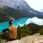 man sitting near lake 3572740